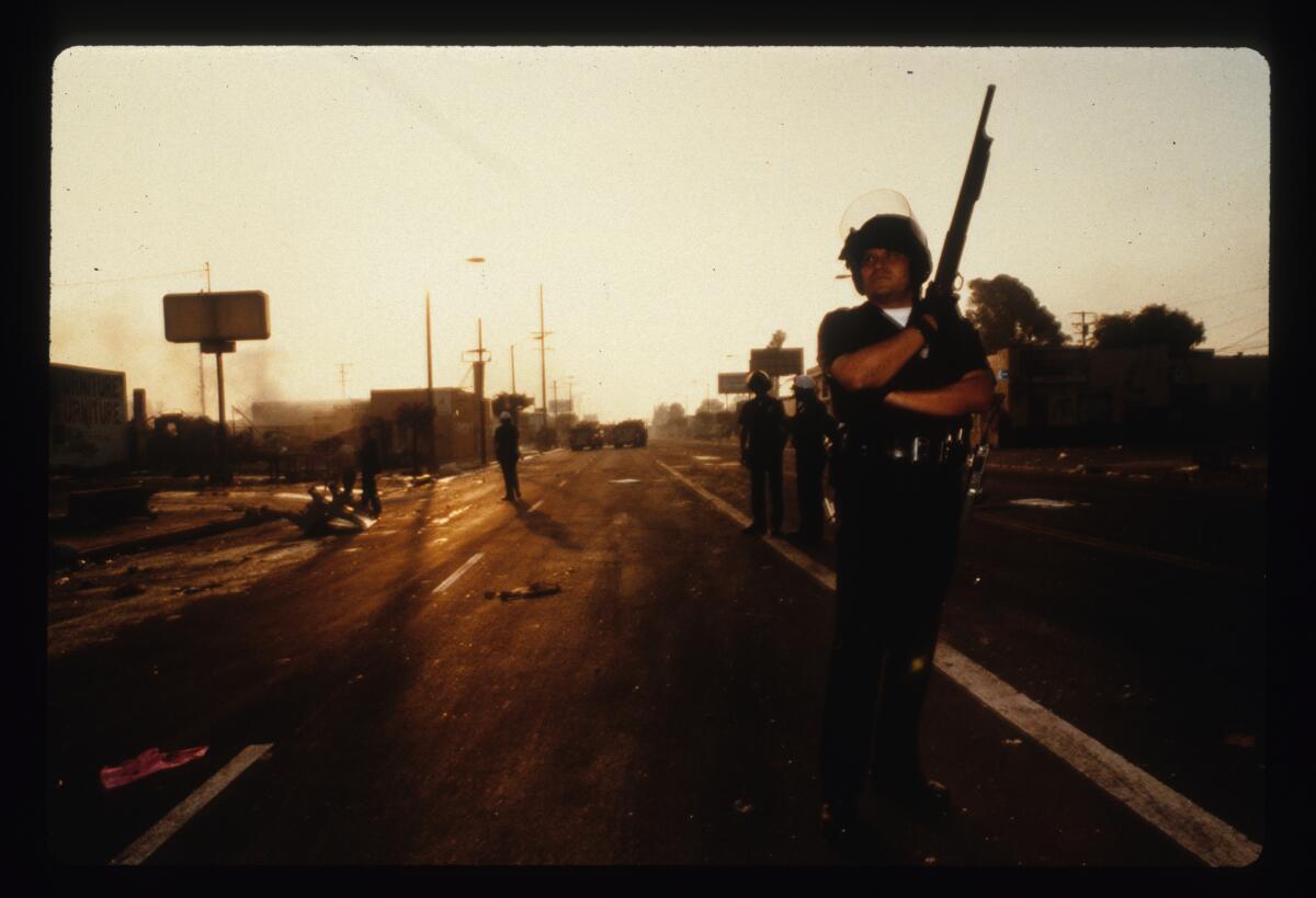 An LAPD officer stands guard at dawn.