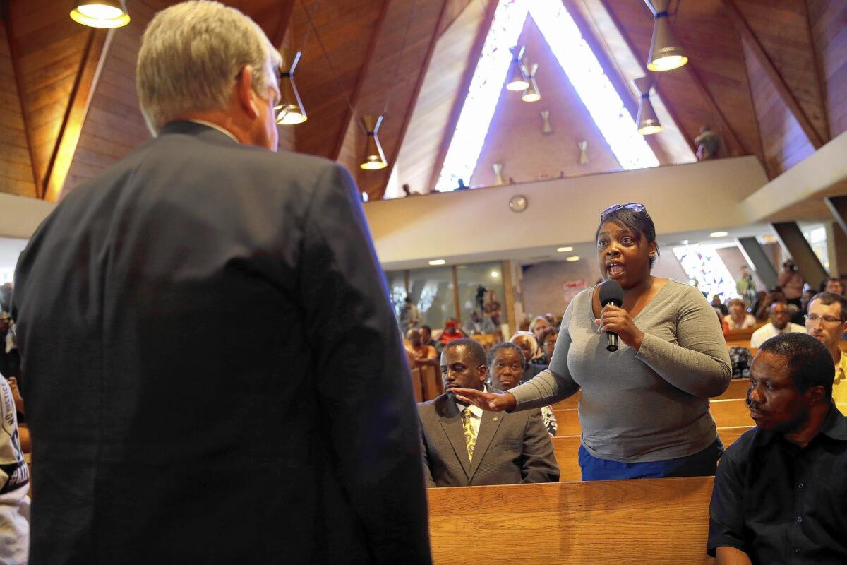 Sierra Smith tells Missouri Gov. Jay Nixon her concerns during a meeting of community members in Florissant, Mo. "Ferguson will not be defined as a community that was torn apart by violence," Nixon said.