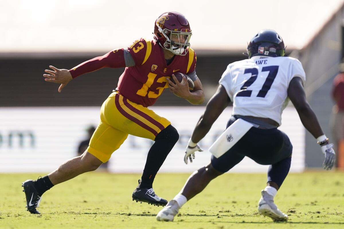 Southern California quarterback Caleb Williams (13) runs the ball against Rice linebacker Andrew Awe (27) during the first half of an NCAA college football game in Los Angeles, Saturday, Sept. 3, 2022. (AP Photo/Ashley Landis)