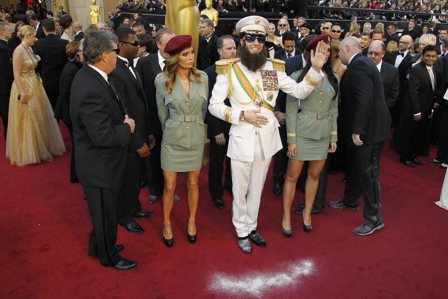 Sacha Baron Cohen's Adm. Gen. Shabazz Aladeen not only made his way onto the Oscar red carpet, the character also made his way over to Ryan Seacrest and managed to stun the usually unflappable host by showering Seacrest with the "ashes" of the late North Korean dictator Kim Jong Il.