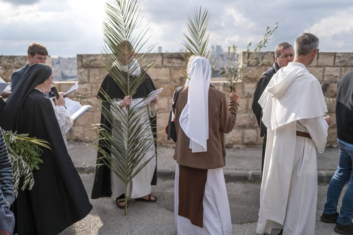 Christians walk in the Palm Sunday procession on the Mount of Olives in east Jerusalem.