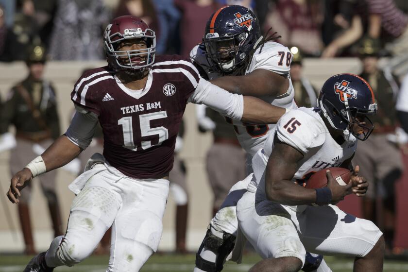 Unlike Leonard Fournette and Christian McCaffrey, Texas A&M defensive lineman Myles Garrett, left, seen making a one-handed sack against UTSA, is a top prospect who chose to play in his team's bowl game.