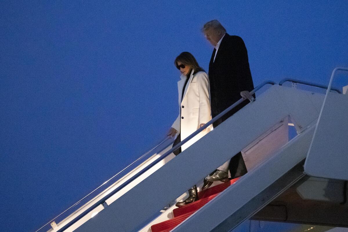 President Trump and First Lady Melania Trump depart Air Force One after arriving Wednesday at Andrews Air Force Base.