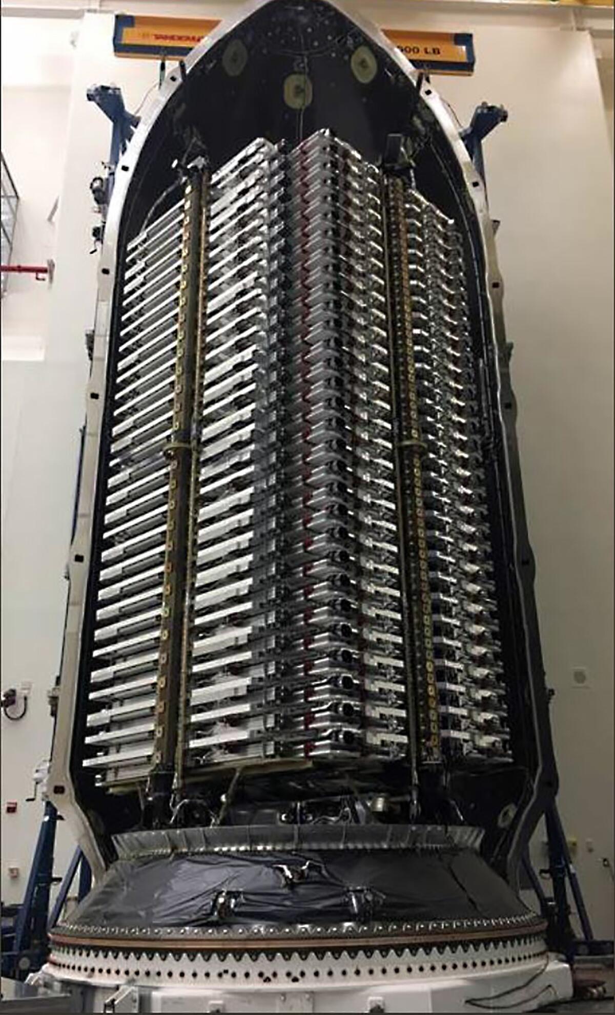 This photo of the first 60 SpaceX Starlink satellites loaded into a Falcon rocket was tweeted out by Elon Musk.