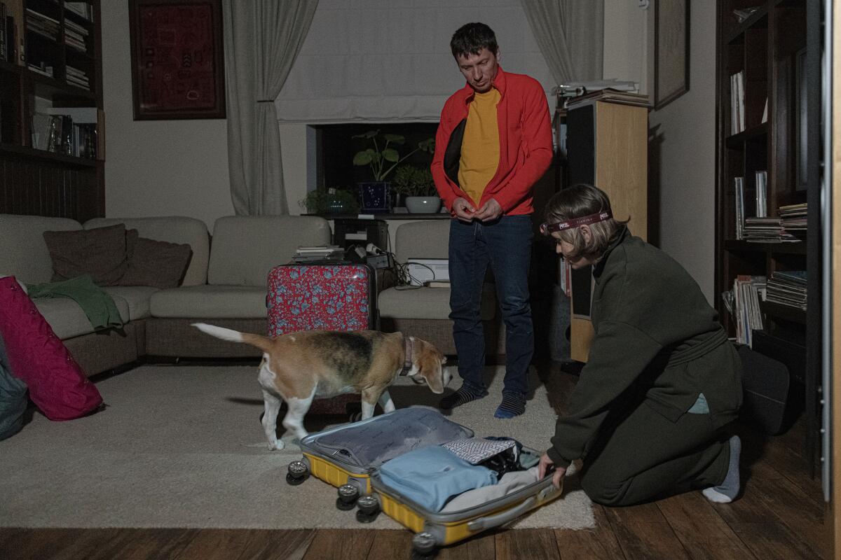 Ukrainian couple and their dog at their home