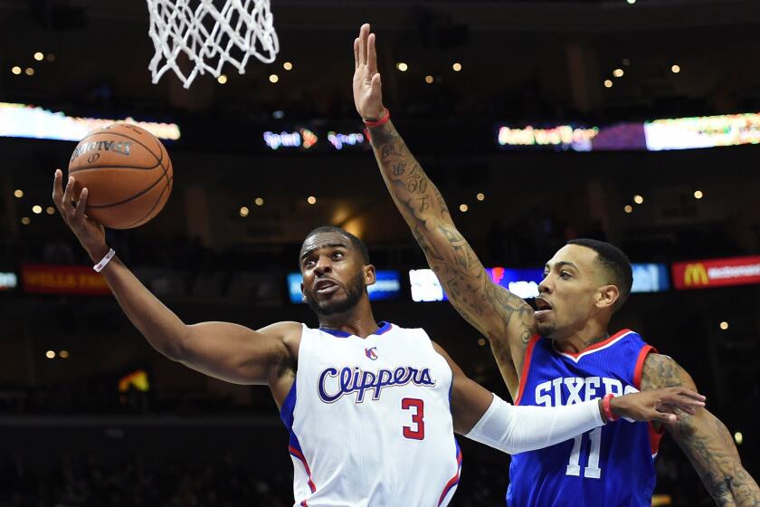 Clippers point guard Chris Paul drives to the basket against 76ers forward Malcolm Thomas during a game Jan. 3.