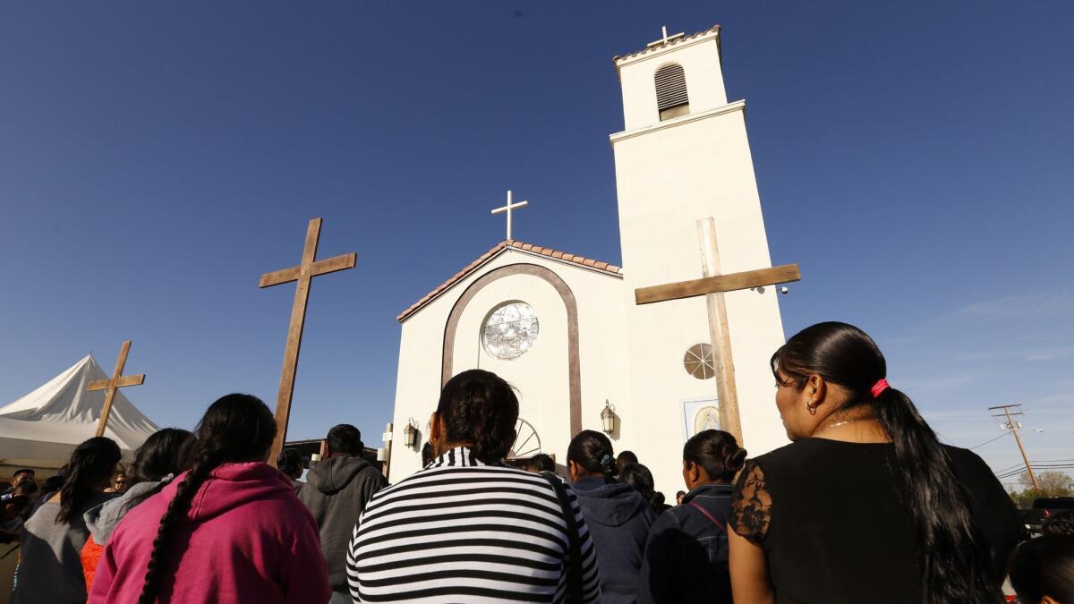 Family and friends attend funeral services on April 2 at Our Lady of Guadalupe Church in Delano for migrant farmworkers, whose vehicle crashed as they fled immigration agents.
