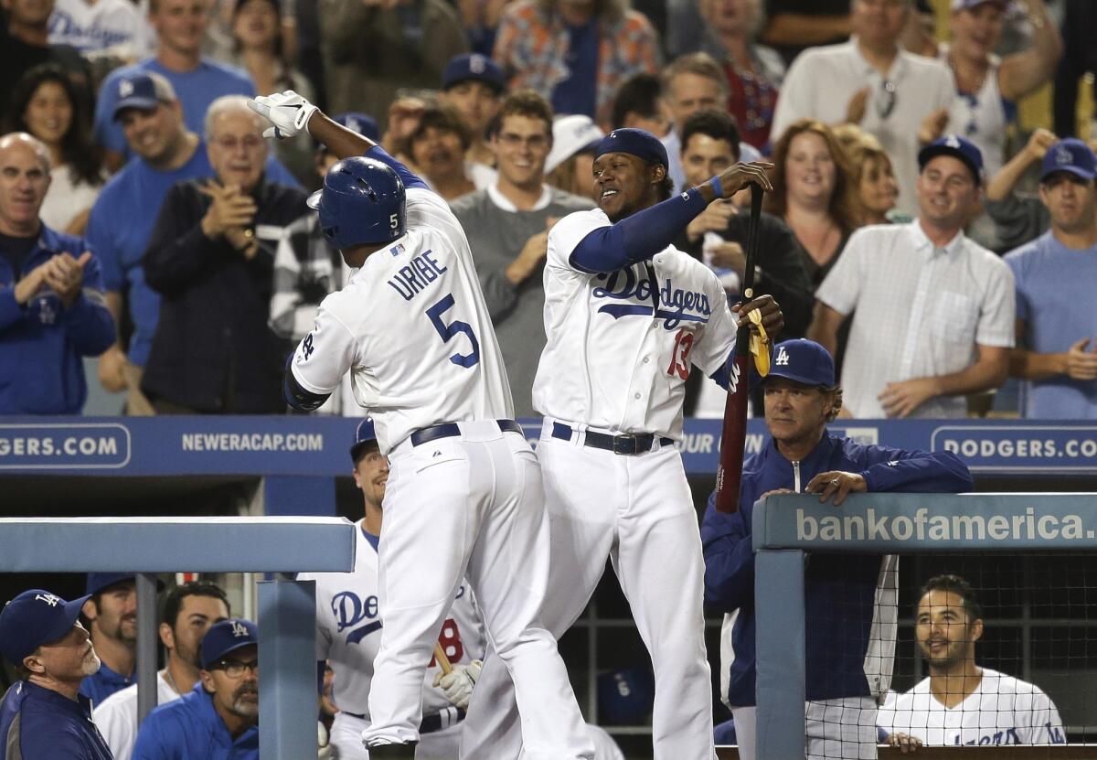 Juan Uribe, left, celebrates his home run with Hanley Ramirez during the Dodgers' 8-1 victory over Arizona.