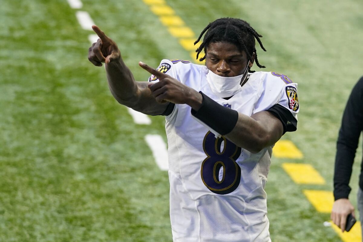 Baltimore Ravens quarterback Lamar Jackson (8) acknowledges fans as he leaves the field following an NFL football game against the Indianapolis Colts in Indianapolis, Sunday, Nov. 8, 2020. The Ravens defeated the Colts 24-10. (AP Photo/Darron Cummings)