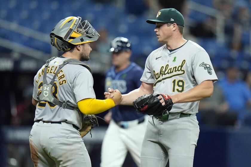 Oakland Athletics relief pitcher Mason Miller (19) celebrates with catcher Shea Langeliers after closing out the Tampa Bay Rays during the ninth inning of a baseball game Tuesday, May 28, 2024, in St. Petersburg, Fla. (AP Photo/Chris O'Meara)