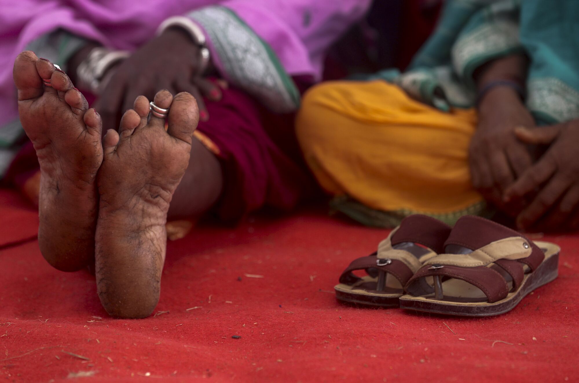 A woman rests her feet during a farmers' rally in Mumbai, India. 