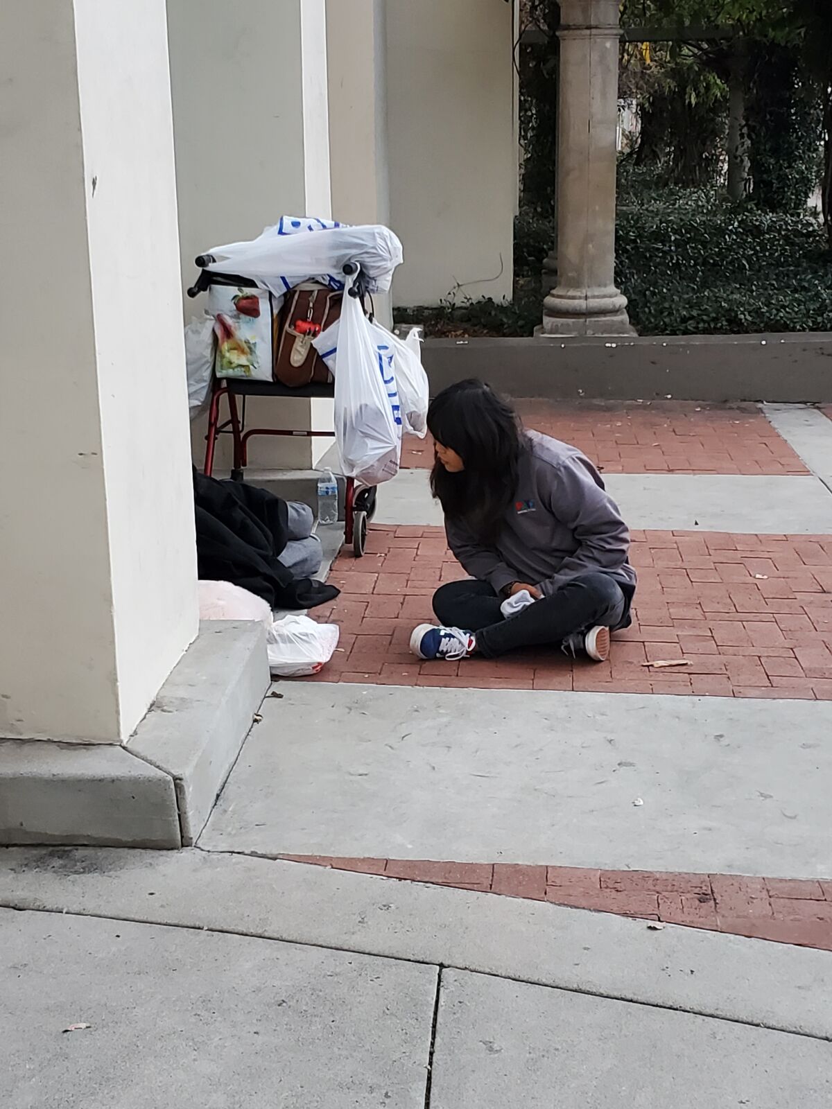 PATH lead outreach specialist Jayna Lee speaks to a man who was sleeping on the street in La Jolla.