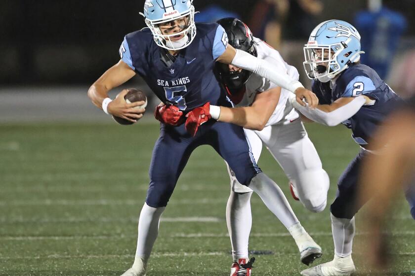 Corona Del Mar quarterback Max Nashed (5) is forced to run and takes a sack in first half during nonleague football game against San Clemente on Friday.