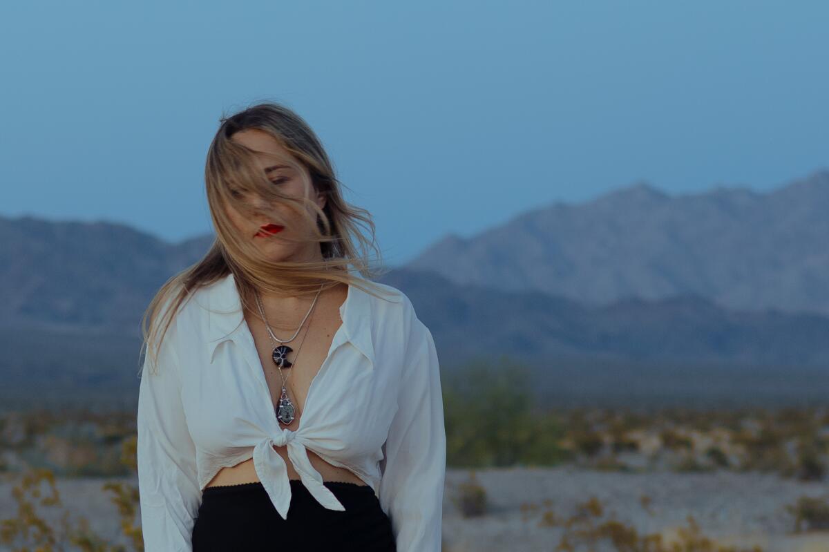 Jamie-Lee Dimes stands among the Joshua Tree wilderness.