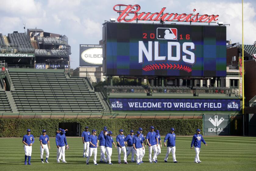Cubs players warm up during a postseason practice at Wrigley Field on Oct. 5.