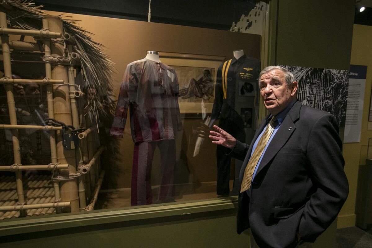  Jack Ensch, a former POW, shows his uniform in the "Captured: Shot Down in Vietnam" exhibit.  