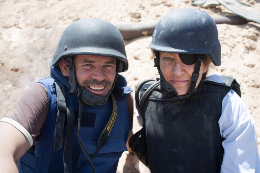 (L-R) - Paul Conroy with Marie Colvin in a scene from "Under the Wire." Credit: PAULCONROY/Times Newspapers Ltd