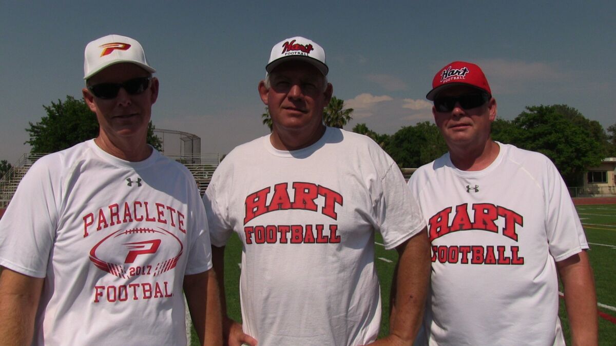 Dean Herrington, left, brother Mike Herrington and brother Rick Herrington before a summer 11-on-11 game. Mike won his 300th coaching victory on Friday at Hart.