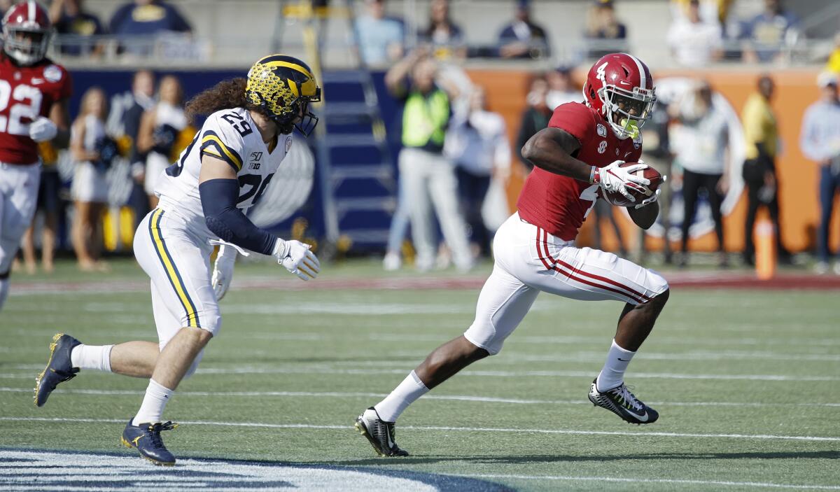Alabama's Jerry Jeudy tries to get past Michigan's Jordan Glasgow on Jan. 1 at the Citrus Bowl. Minnesota beats Auburn in the Outback Bowl.