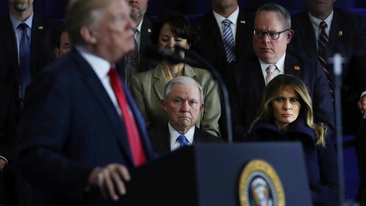 Atty. Gen. Jeff Sessions and First Lady Melania Trump watch as President Trump speaks about the opioid epidemic in Manchester, N.H., on March 19.