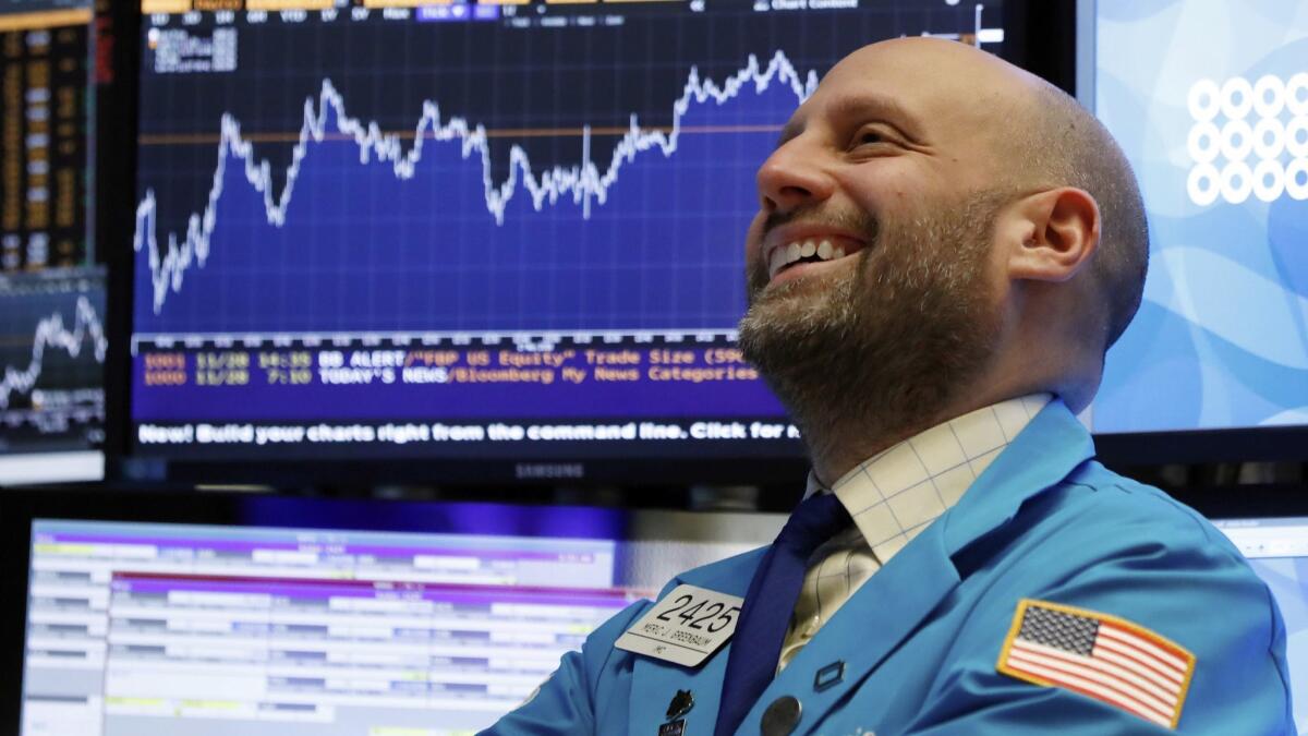 Specialist Meric Greenbaum smiles as he works on the floor of the New York Stock Exchange near the close of trading Wednesday.