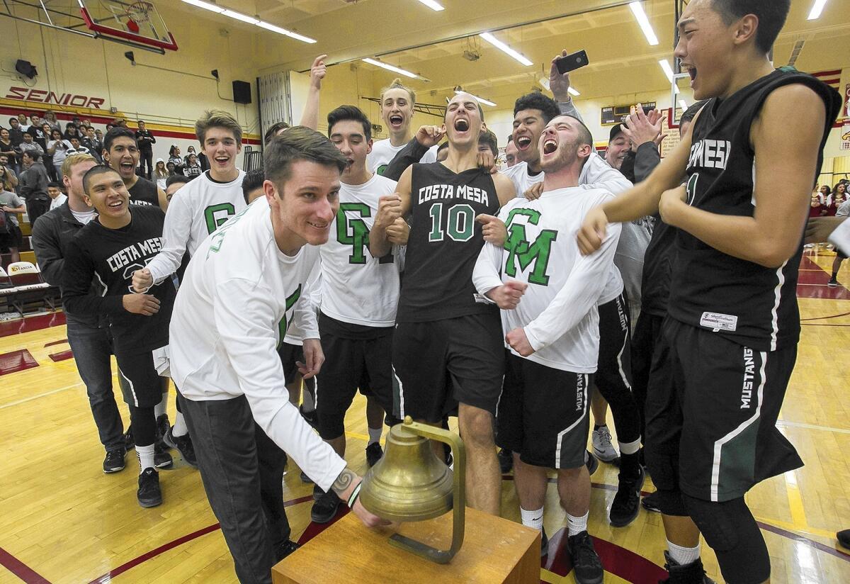 Costa Mesa High Coach Phil Weber rings the bell following a 57-40 victory over Estancia in the final game of the Battle for the Bell series on Friday.