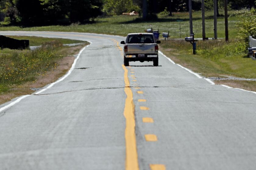 A pickup truck navigates a rural road in Orange County near Hillsborough, N.C., Monday, May 11, 2020. Americans are slowly getting back on the road after hunkering down amid the cornonavirus pandemic, though driving still is well below what it was before many states issued stay-at-home orders. (AP Photo/Gerry Broome)