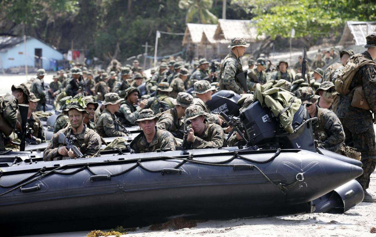 Filipino Marines and U.S. troops simulated an amphibious assault on an unspecified hostile area during a joint military exercise held at the Philippines Marine Base in Tarnate last week. Rival claims of sovereignty over islands and fishing grounds in the South China Sea have strained relations between Asian powerhouses and small states, and the conflict is expected to figure high on the agenda at Wednesday's summit of the Assn. of Southeast Asian Nations in Brunei.