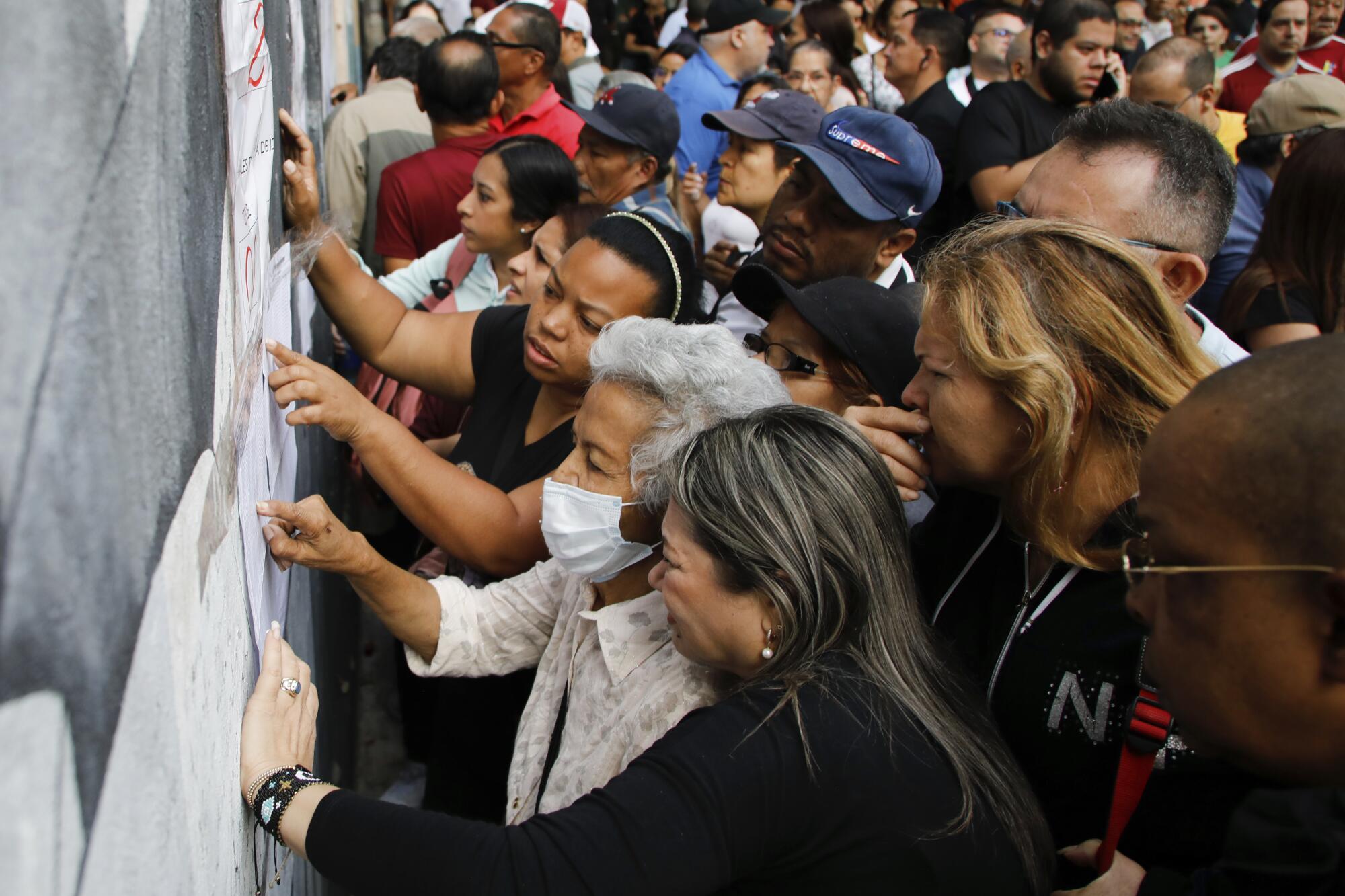 La gente busca sus mesas de votación asignadas durante las elecciones 