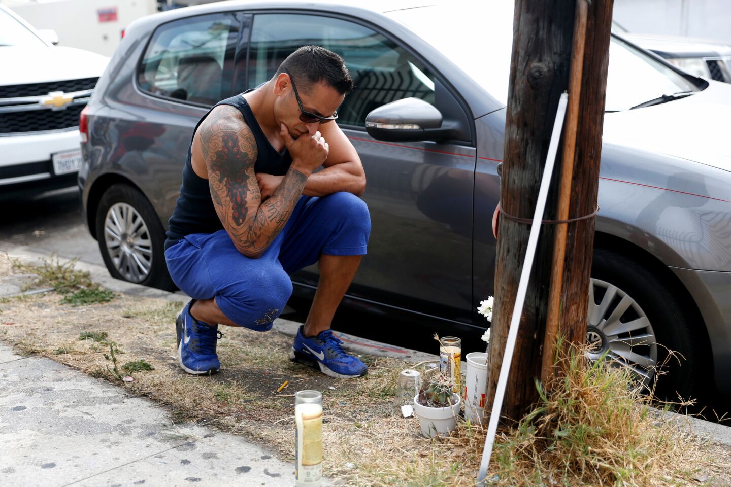Tony Marquez of Boyle Heights, at a makeshift shrine near where Jesse Romero, 14, was shot and killed by police along the 200 block of North Breed Street in Boyle Heights.