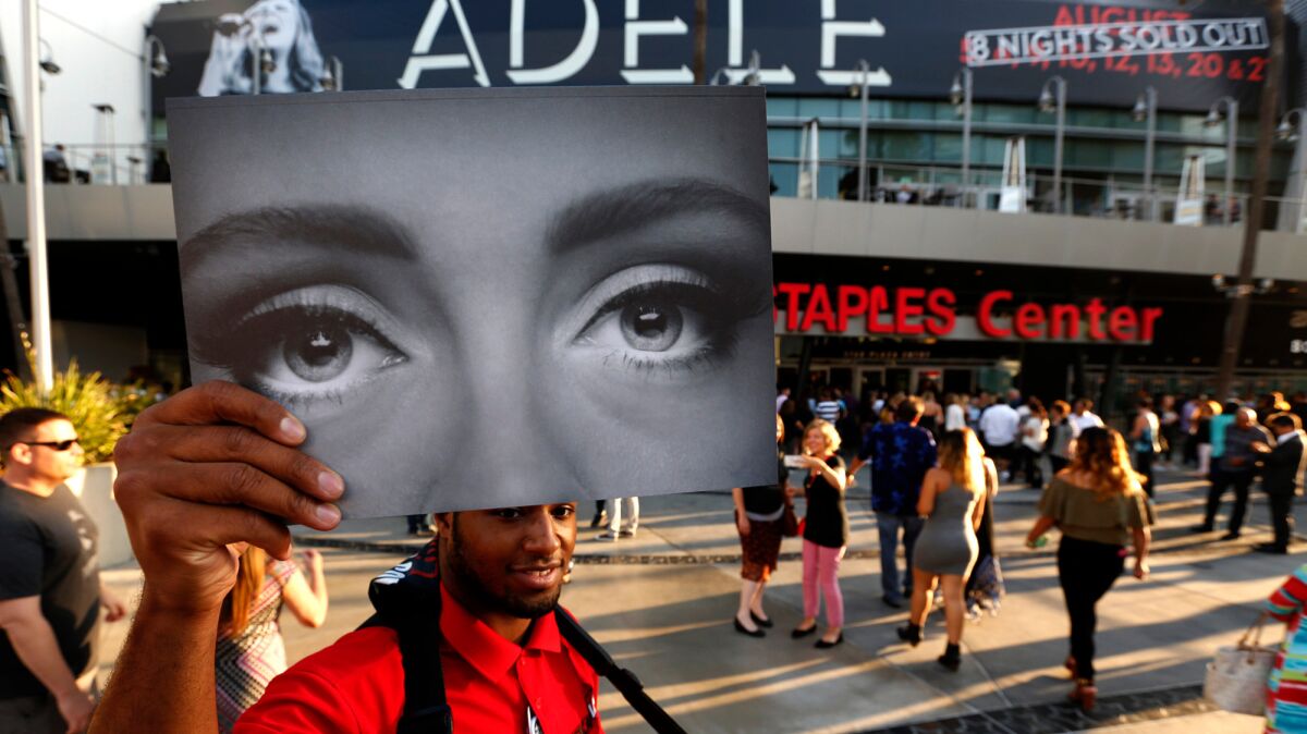 Elton Rodgers, 25, selling Adele programs outside Staples.
