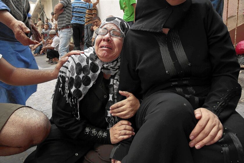 A woman at a hospital in Gaza City cries for her sister who was killed in an Israeli strike.