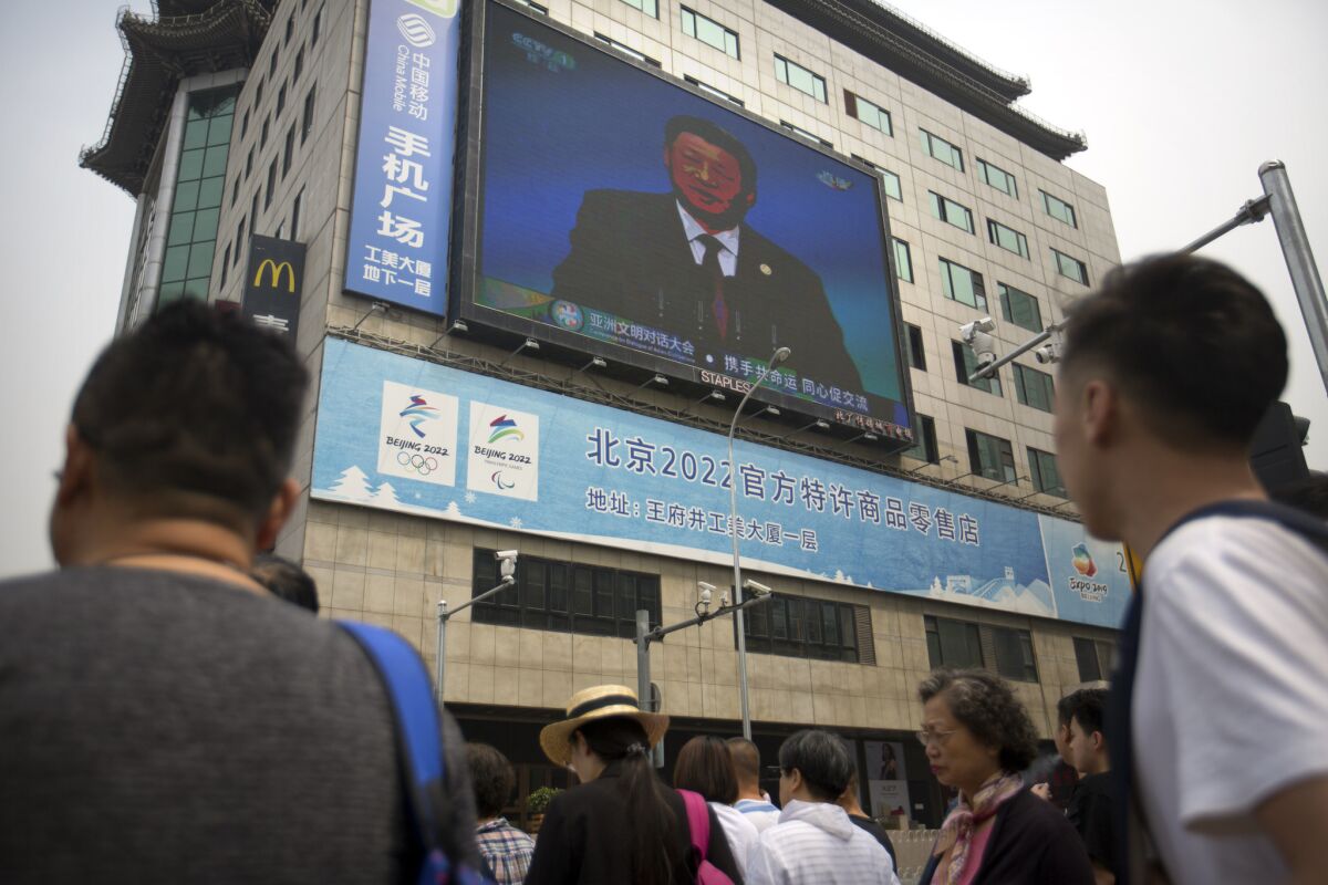 A video screen in Beijing shows Chinese President Xi Jinping.
