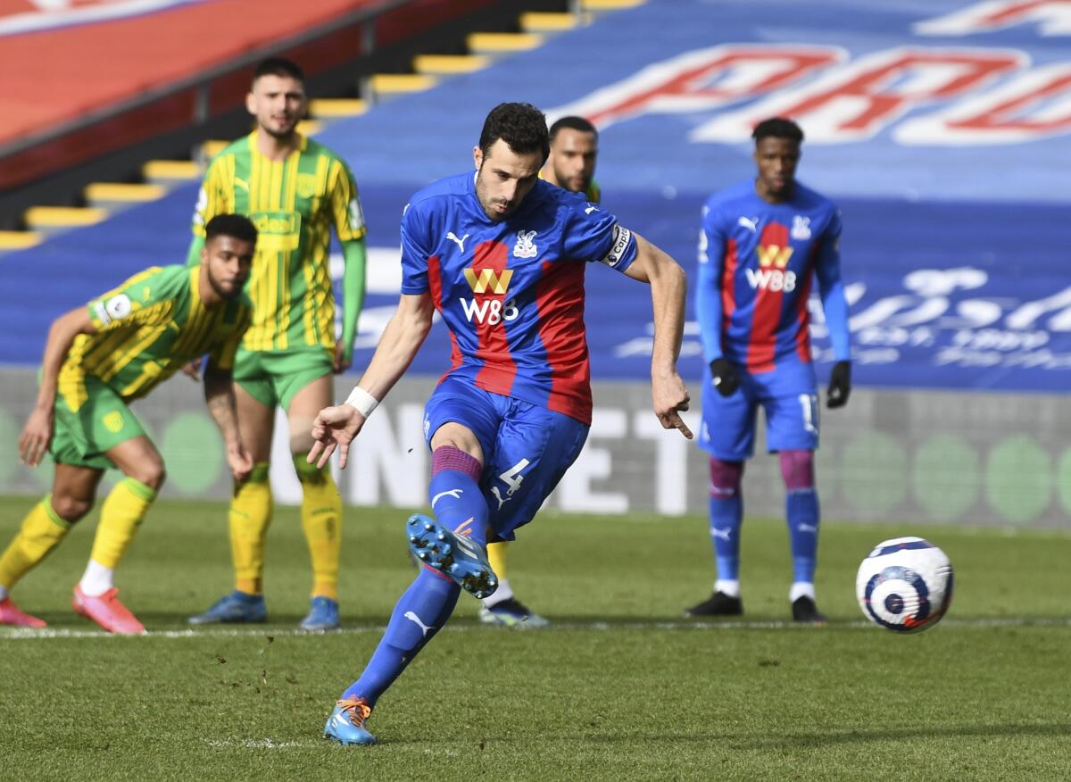 Crystal Palace's Luka Milivojevic scores on a penalty kick during the English Premier League soccer match between Crystal Palace and West Bromwich Albion at Selhurst Park stadium in London, England, Saturday, March 13, 2021.(Mike Hewitt/Pool via AP)