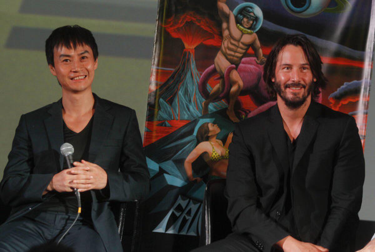 Tiger Chen, left, and Keanu Reeves answer questions following the U.S. premiere of "Man of Tai Chi" in Austin, Texas.