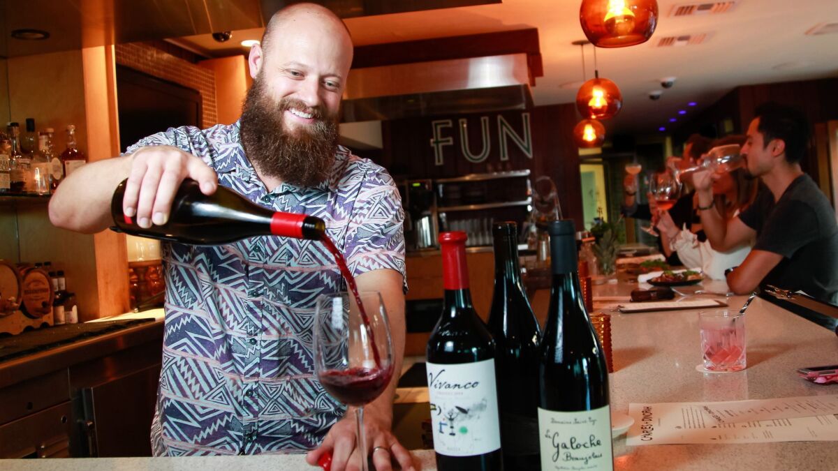 TJ Majeske, bar manager at Charles + Dinorah at The Pearl hotel in Point Loma, pours a Siduri Willamette Valley pinot noir, one of the choices on the modest-sized wine list. The restaurant offers both good variety and value from wineries large and small.