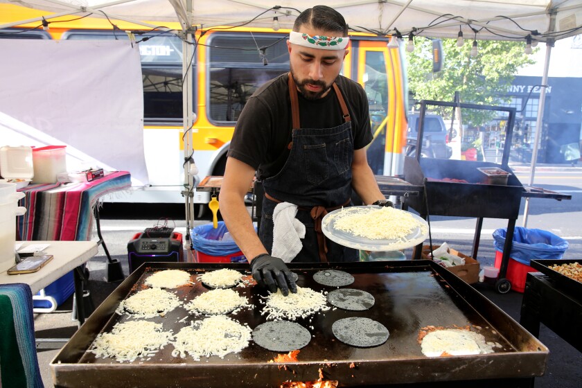 Villa's Tacos owner Victor Villa makes a batch of the unique cheese and blue corn tortilla tacos.