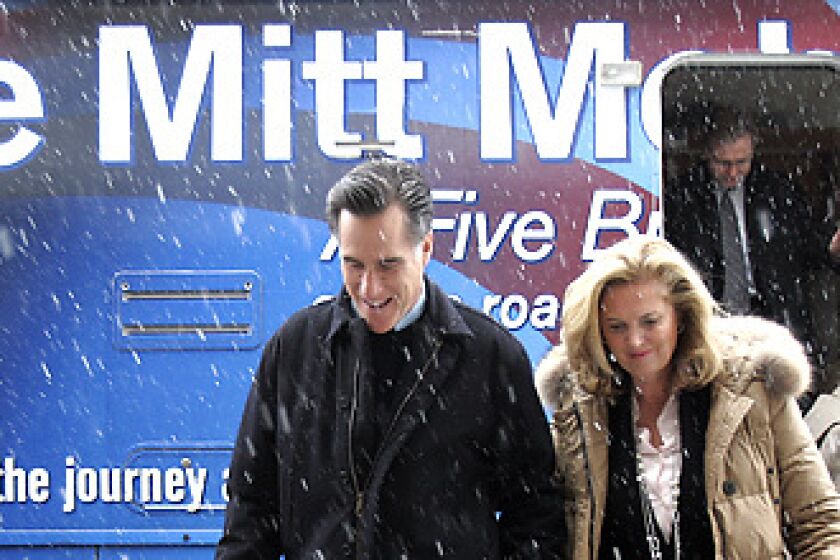 ITS COMING DOWN: Mitt Romney in Rock Rapids, Iowa, with wife Ann. His ads say John McCain voted against the Bush tax cuts twice and Mike Huckabee is soft on government spending.