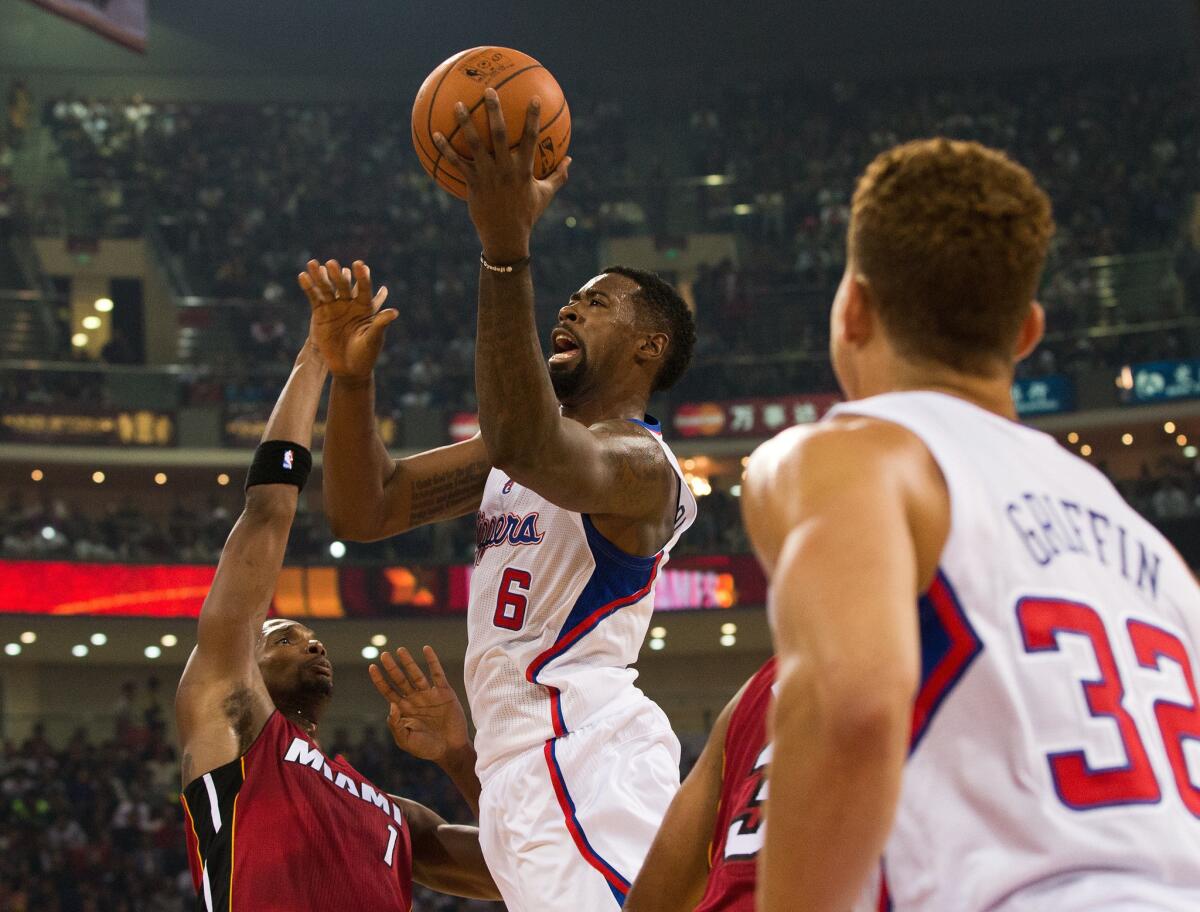 Clippers center DeAndre Jordan goes up for a basket past Heat forward Chris Bosh during a 2012 preseason NBA China Game at Wukesong Arena in Beijing.