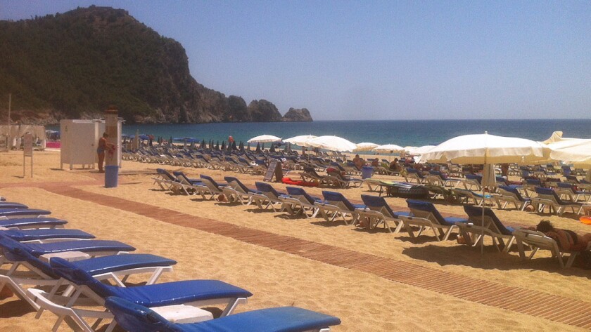 Empty beach chairs line the shore in Alanya, Turkey.