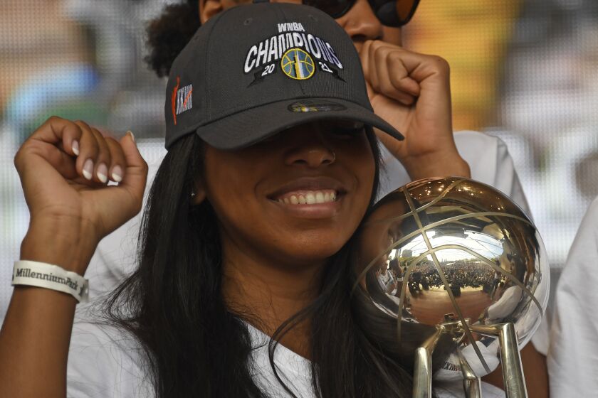 CORRECTS ID TO LEXIE BROWN, NOT KAHLEAH COPPER - Chicago Sky'S Lexie Brown holds the trophy while she and teammates celebrate their 2021 WNBA Championship during a rally at Millennium Park on Tuesday, Oct. 19, 2021, in Chicago. (AP Photo/Matt Marton)