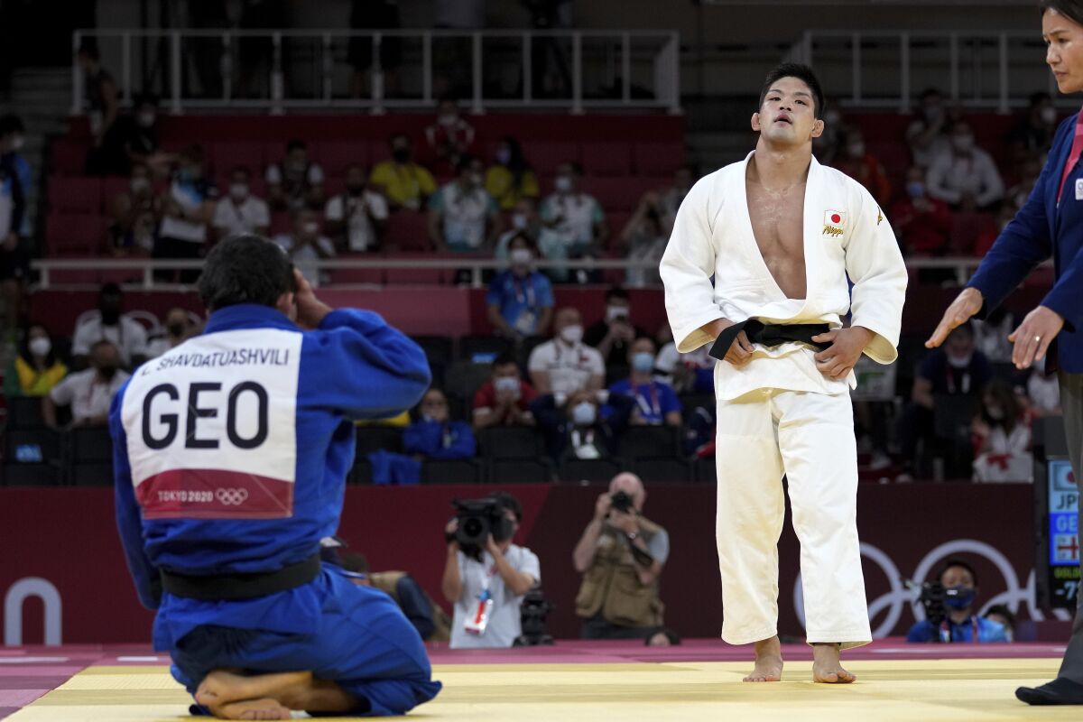 Japan's Shohei Ono reacts after defeating Lasha Shavdatuashvili of Georgia