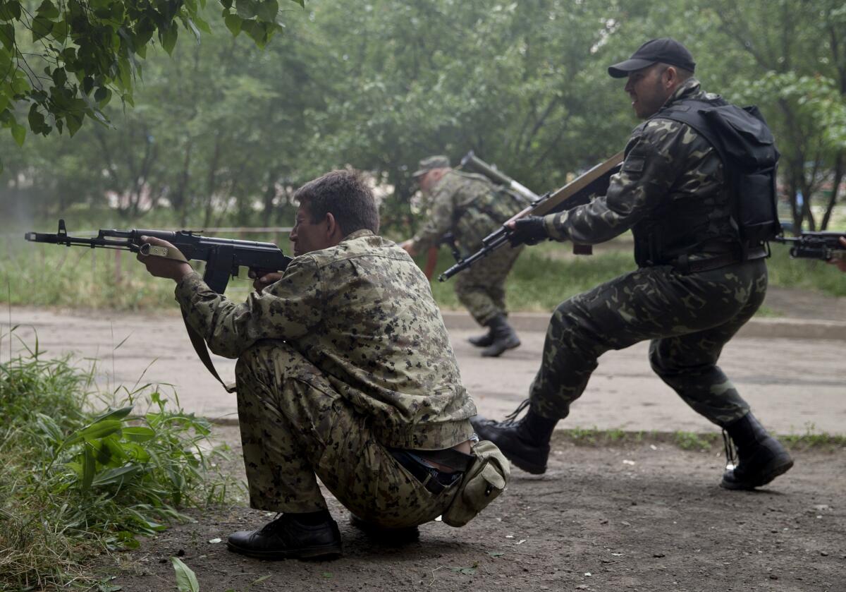 Pro-Russian rebels fire on a Ukrainian border guard base Monday in Mirny, near Luhansk.