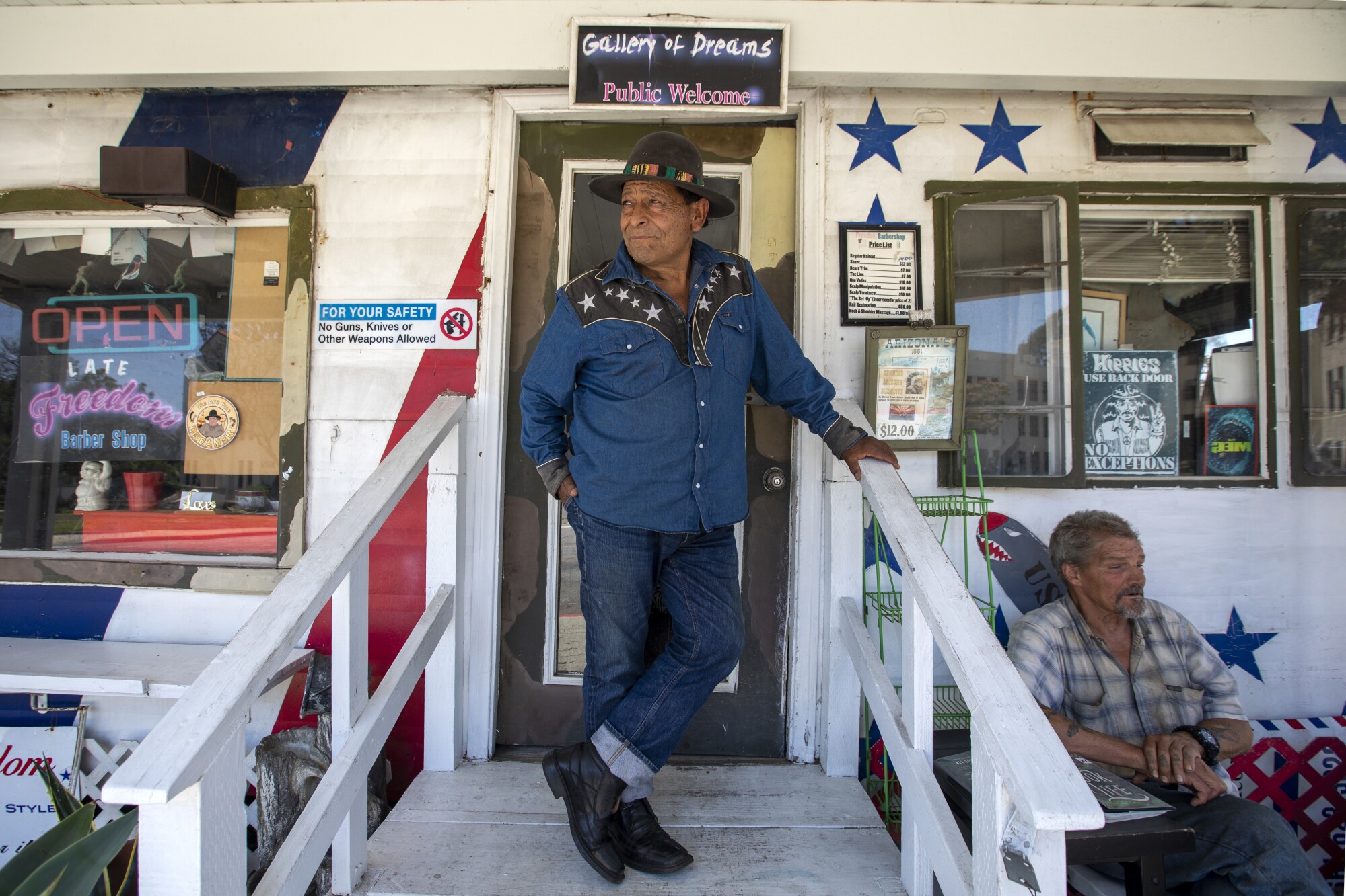 Barber Tony Bravo stand outside the barber shop.