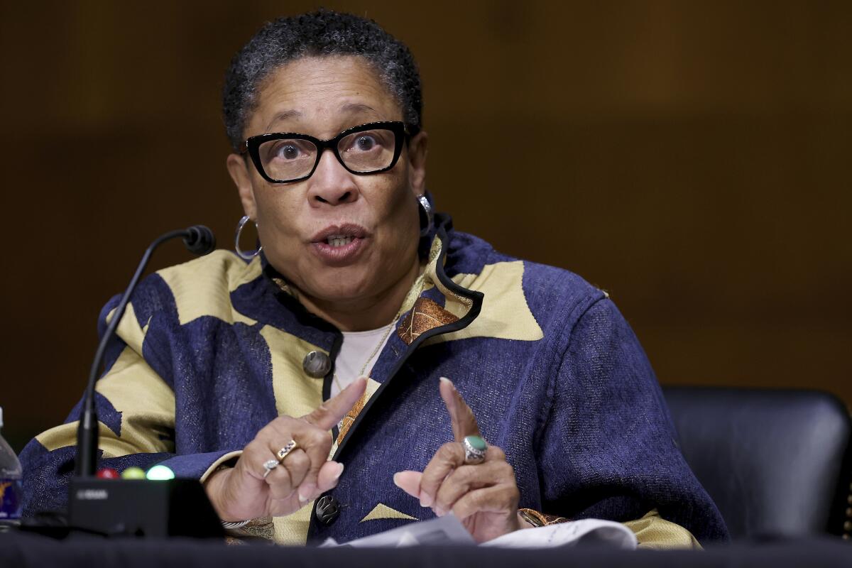 Marcia Fudge gestures as she speaks into a microphone.