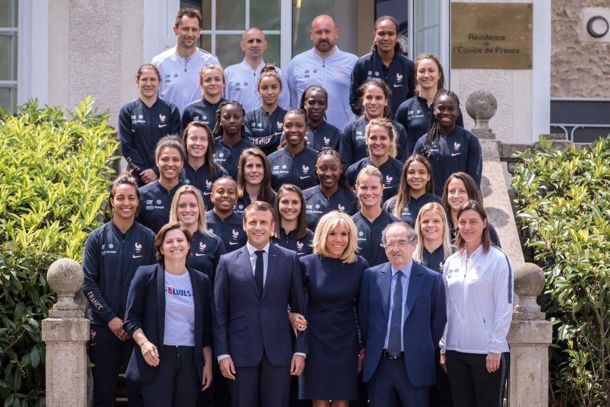 French Sports Minister Roxana Maracineanu, President Emmanuel Macron, First Lady Brigitte Macron, French Football Federation president Noel Le Graet and national team coach Corinne Diacre stand in front of players and staff members June 4 at Clairefontaine.