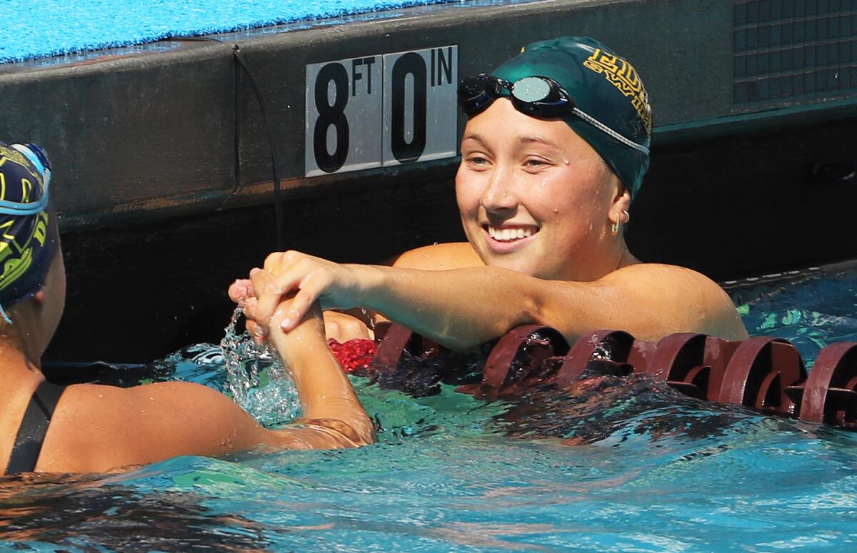 Edison's Gaby Kelly shakes her opponent's hand after completing the 200-yard IM.