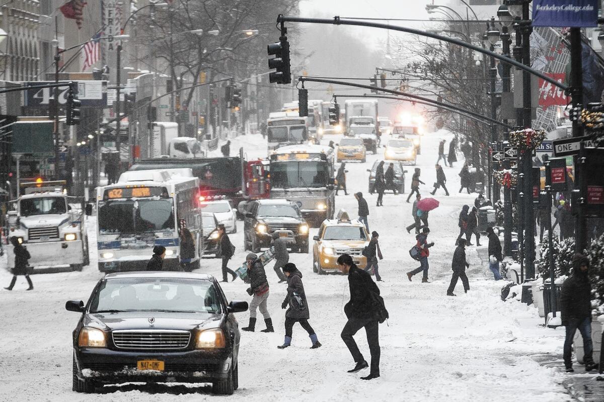 Snow covers Fifth Avenue in New York City, where some boroughs saw 11 inches.