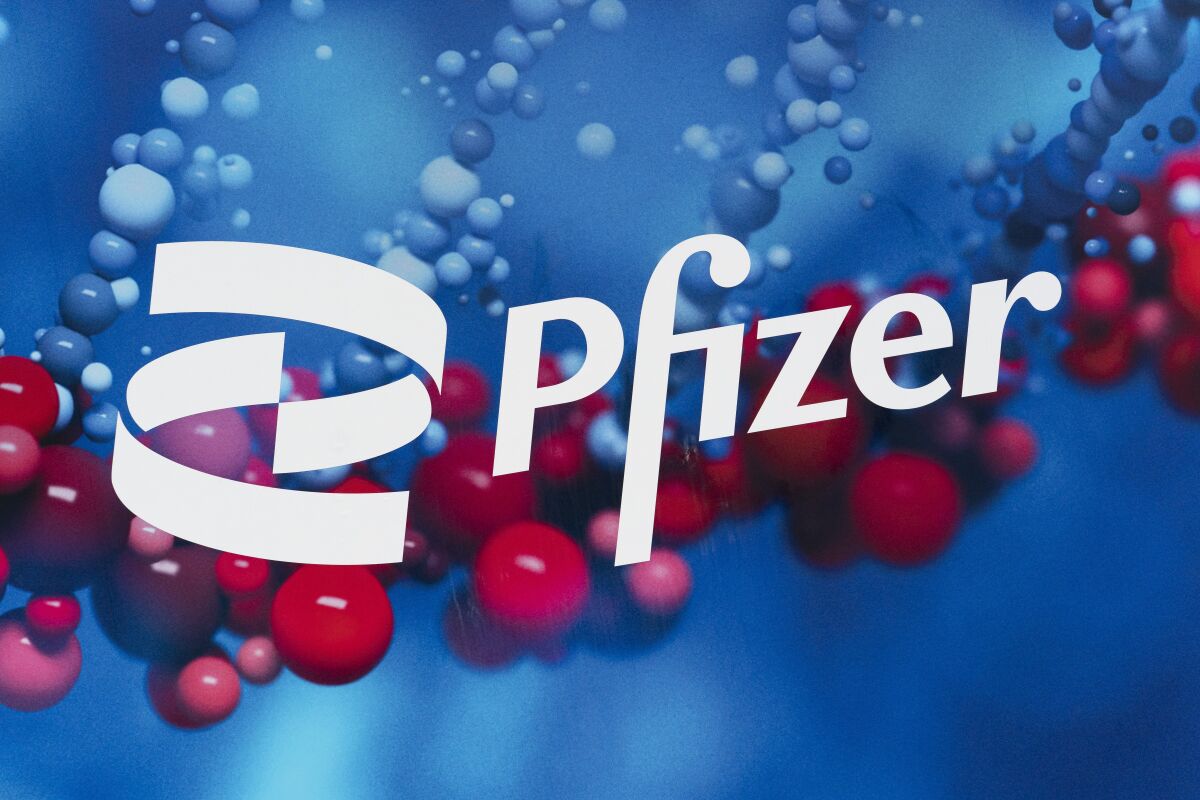 The Pfizer logo is displayed at the company's headquarters, Friday, Feb. 5, 2021, in New York. COVID-19 vaccine sales boosted Pfizer earnings well past expectations in the final quarter of 2021, Tuesday, Feb. 8, 2022, but the drugmaker is setting a lower-than-expected bar for 2022. (AP Photo/Mark Lennihan)