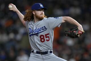Los Angeles Dodgers pitcher Dustin May throws to a San Francisco Giants.
